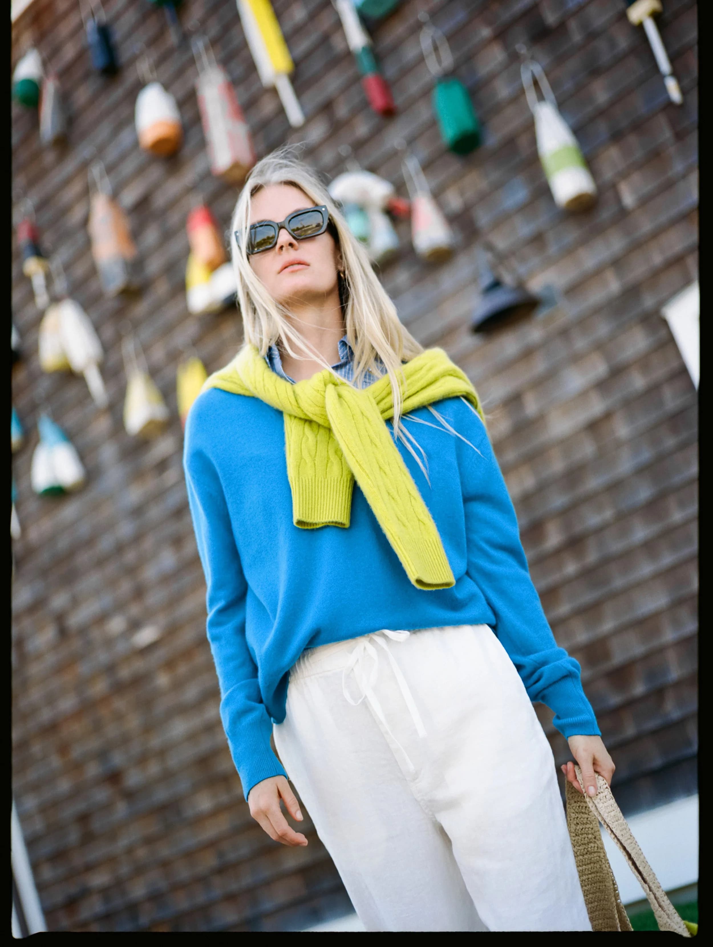 Model in a bright azure cashmere V-neck.