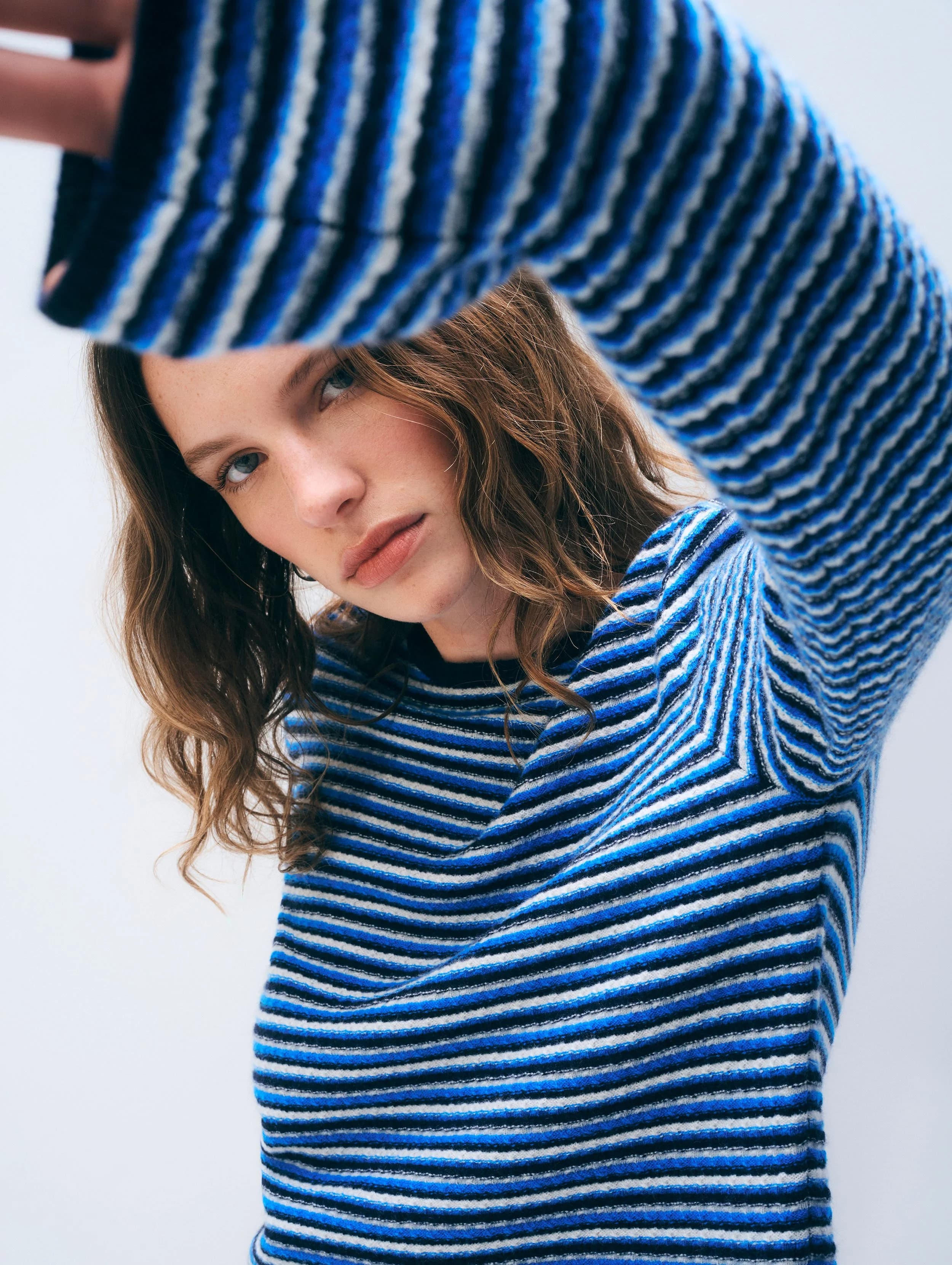 Model in a striped cashmere sweater.