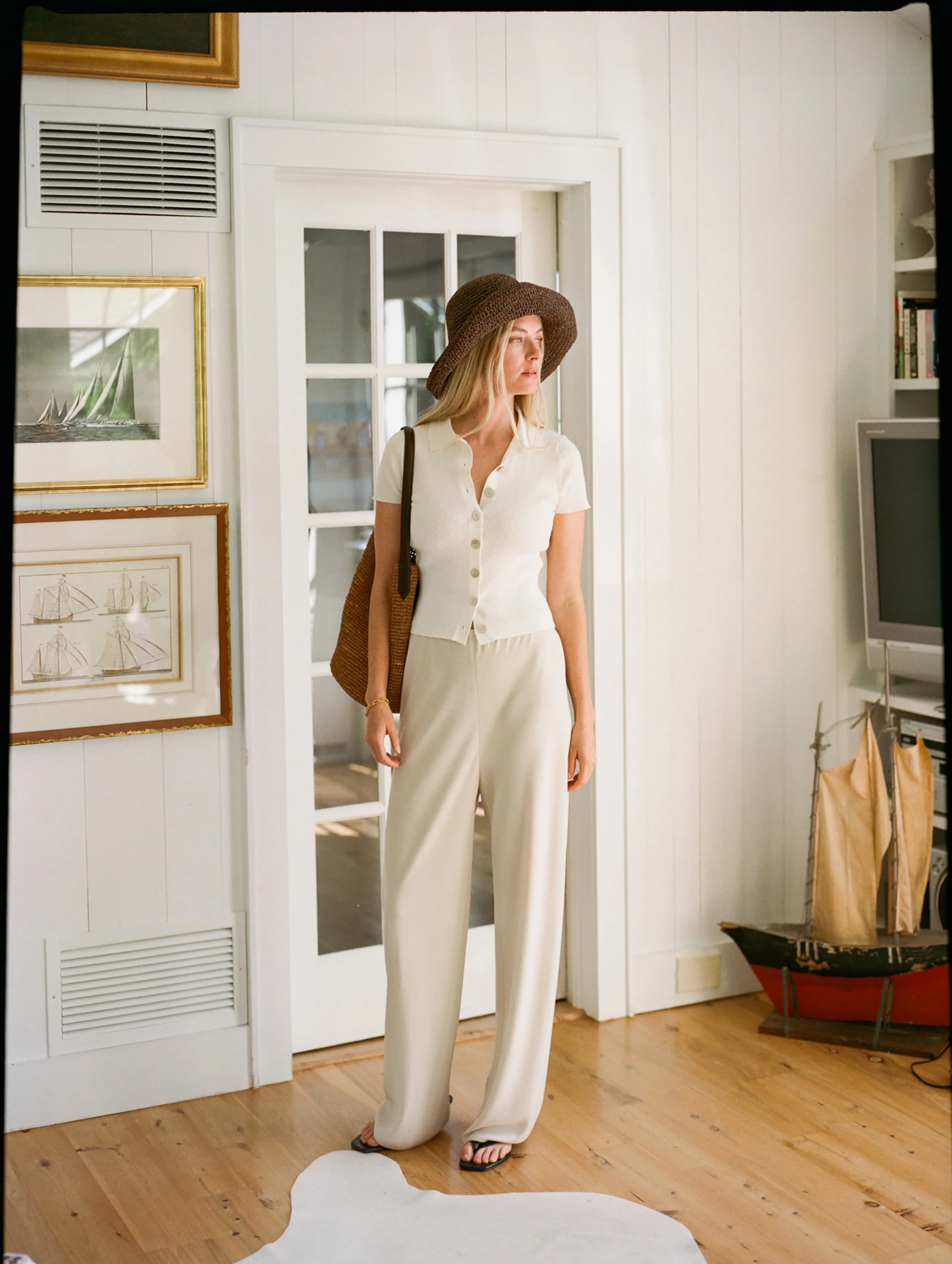 Model in a white linen blend top.